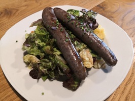 Wildbratwürste auf Salatteller